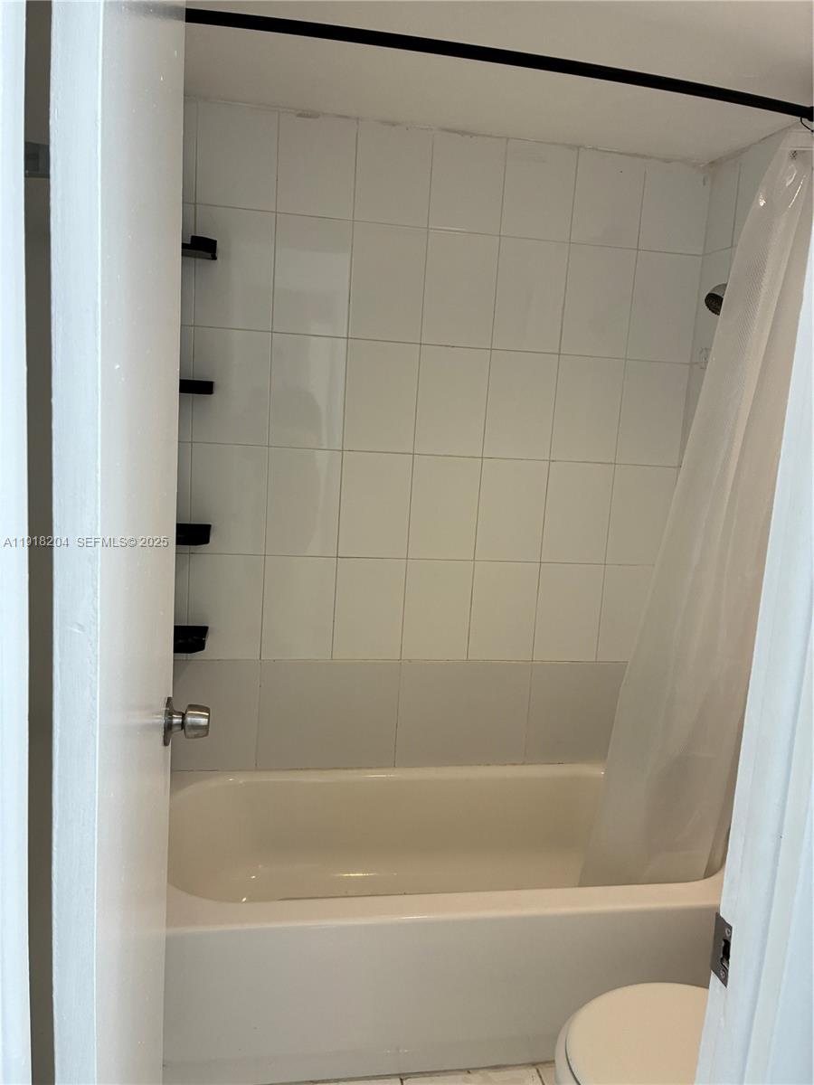 10801 Southwest 109th Court, Unit D203 Miami, FL 33176 - Photo 13 of 28 a bathroom with a shower and a toilet