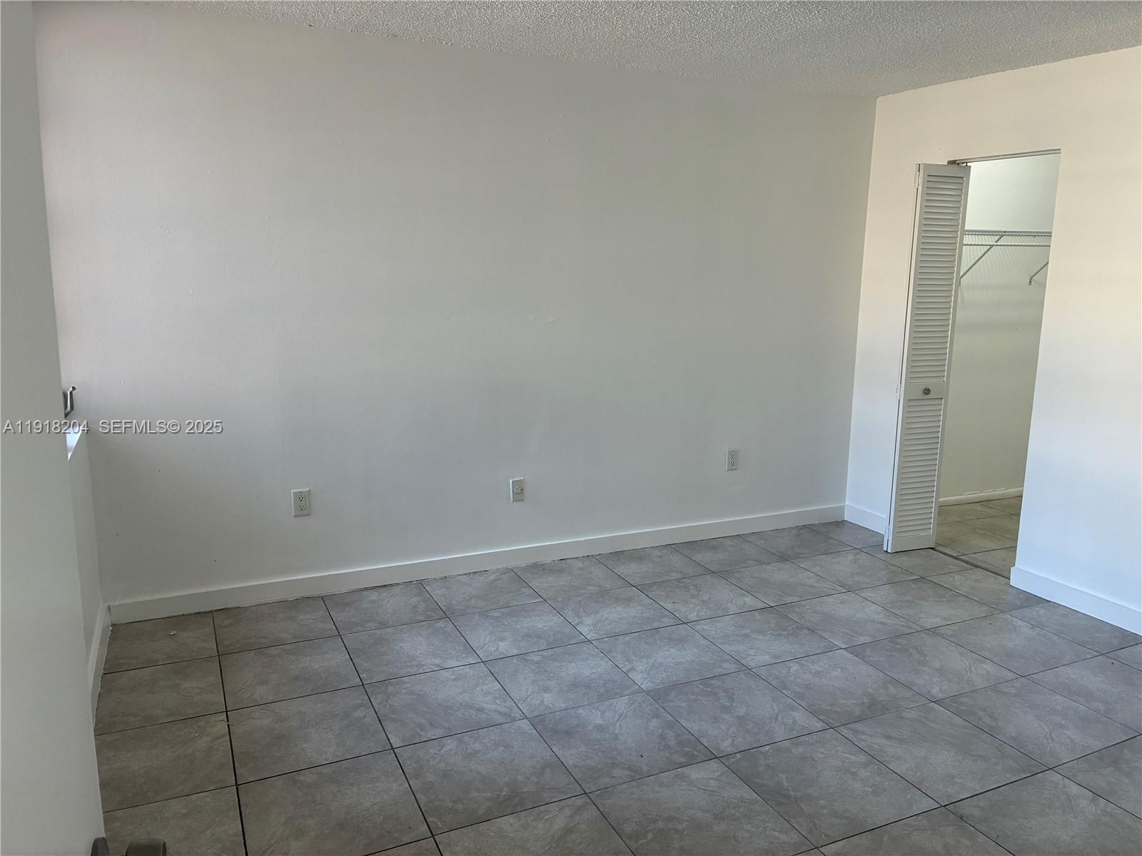 10801 Southwest 109th Court, Unit D203 Miami, FL 33176 - Photo 15 of 28 a view of an empty room and window