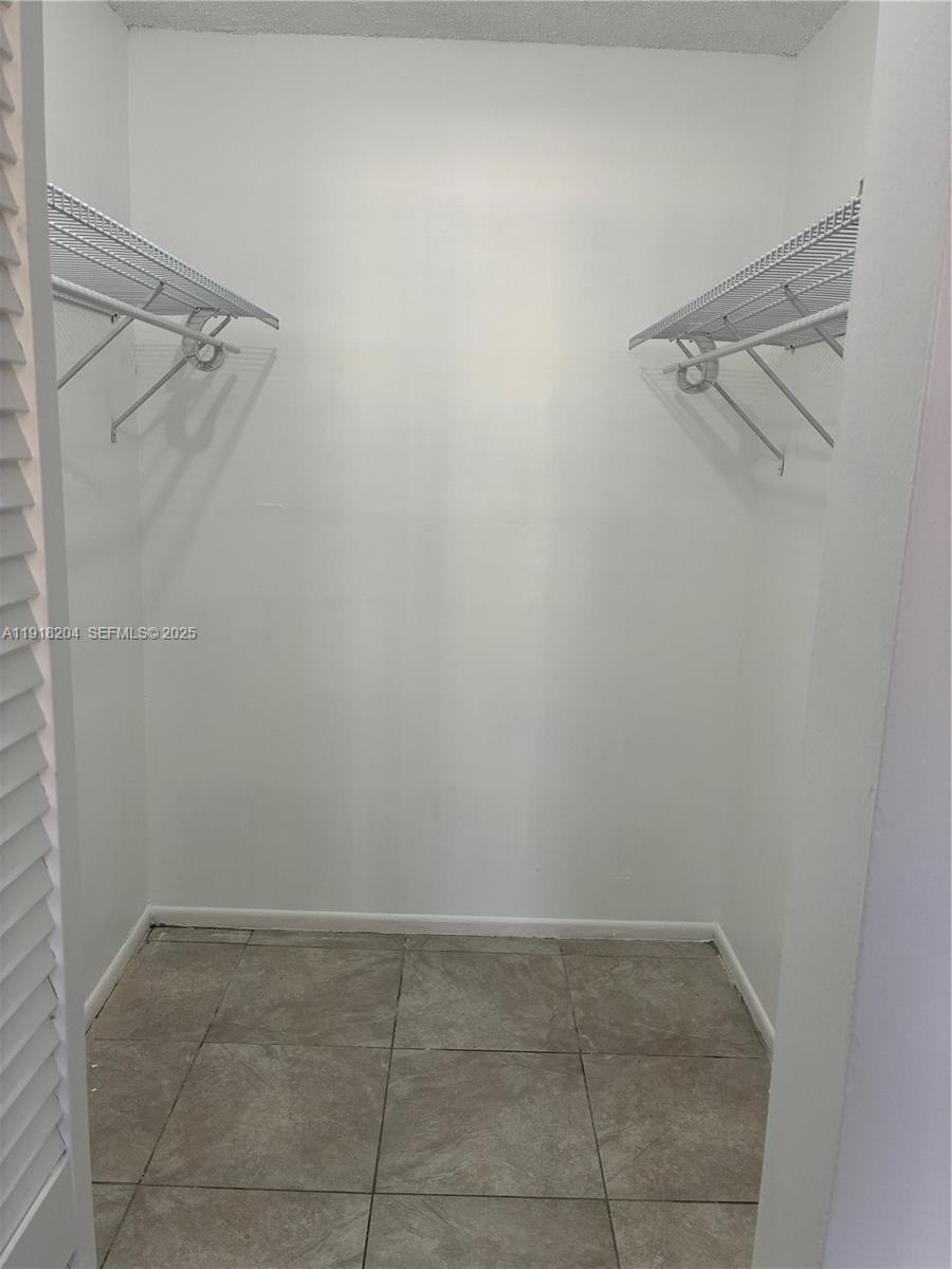10801 Southwest 109th Court, Unit D203 Miami, FL 33176 - Photo 16 of 28 a view of a room with racks on the wall