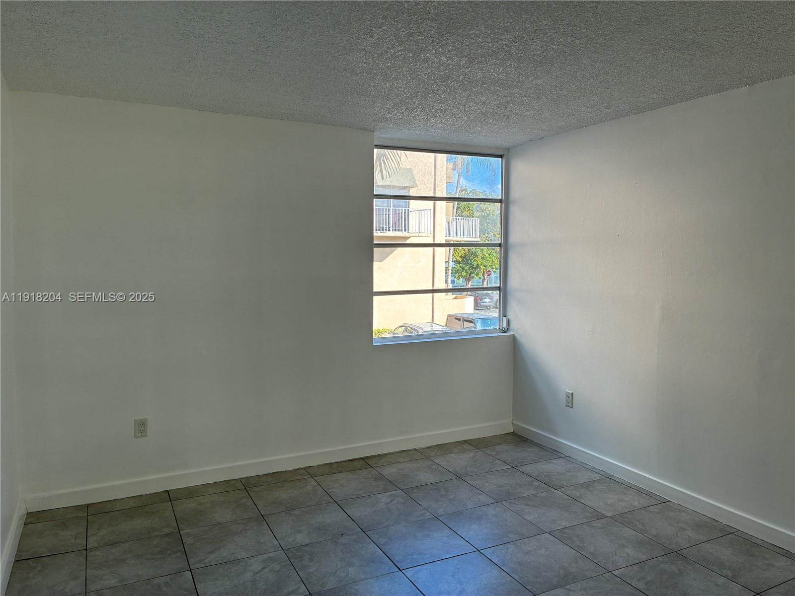 10801 Southwest 109th Court, Unit D203 Miami, FL 33176 - Photo 18 of 28 an empty room with a window