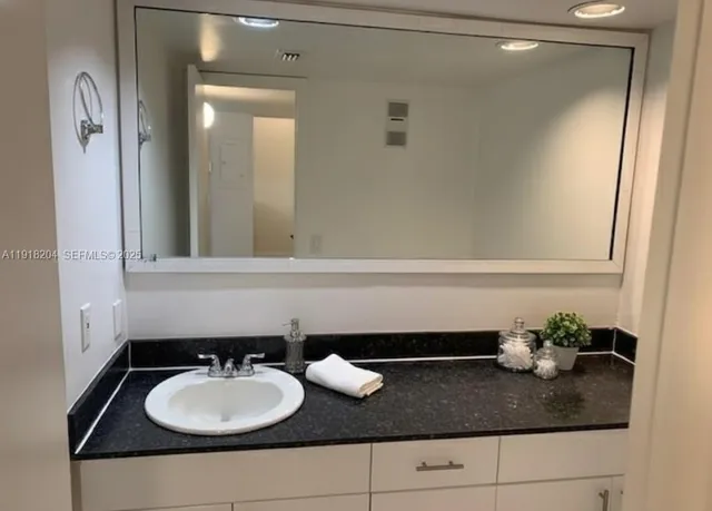 a kitchen with a sink and a stove top oven