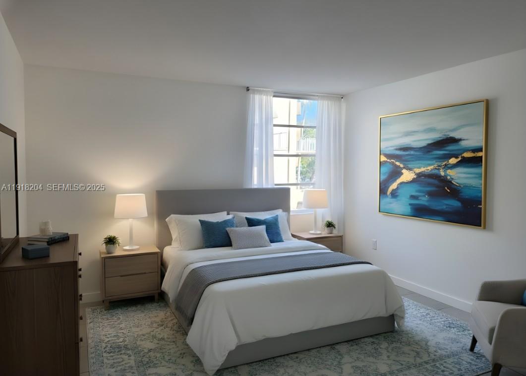 10801 Southwest 109th Court, Unit D203 Miami, FL 33176 - Photo 24 of 28 a bedroom with a bed a couch and a window