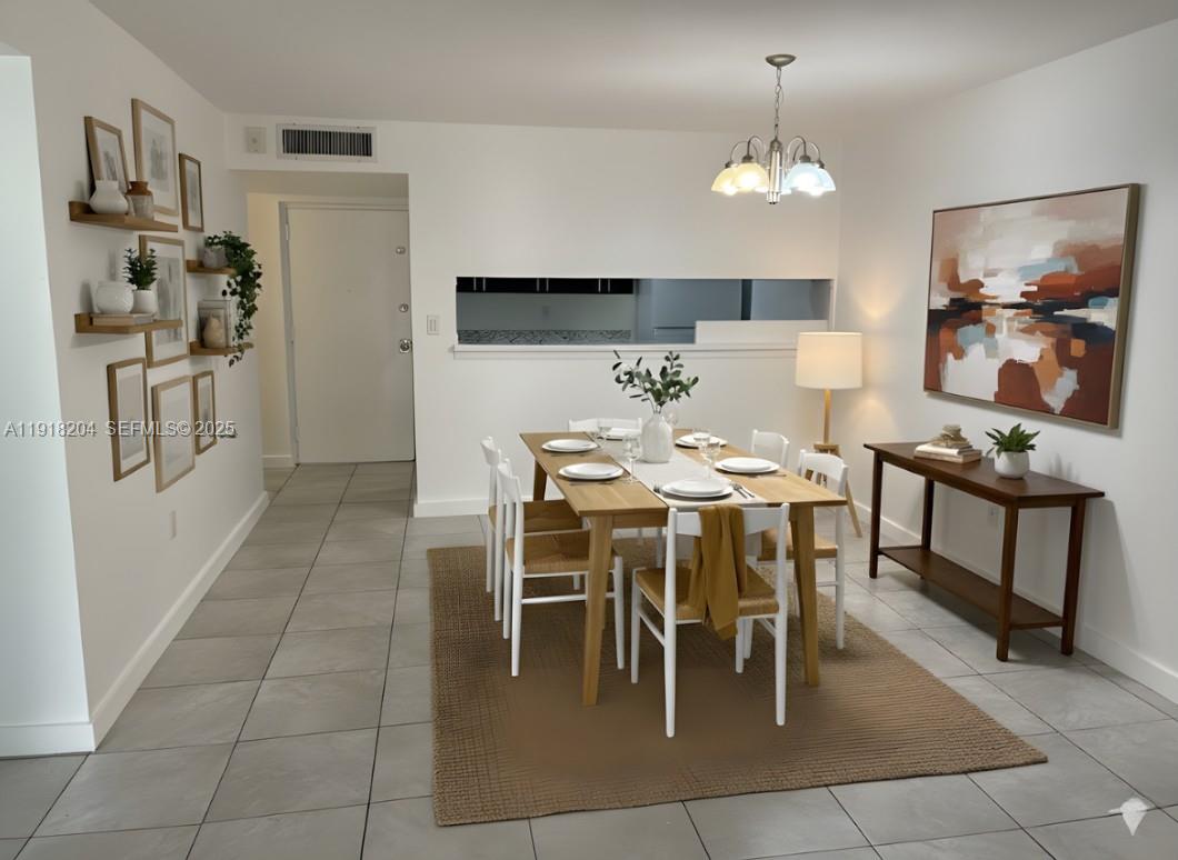 10801 Southwest 109th Court, Unit D203 Miami, FL 33176 - Photo 27 of 28 a dining room with stainless steel appliances kitchen island granite countertop a table chairs and a refrigerator