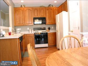 88 Threadleaf Terrace Burlington, NJ 08016 - Photo 2 of 10 a kitchen with stainless steel appliances granite countertop a refrigerator a stove top oven a sink dishwasher and white cabinets with wooden floor