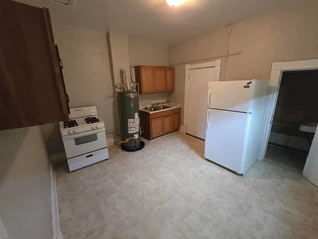 a view of kitchen and refrigerator