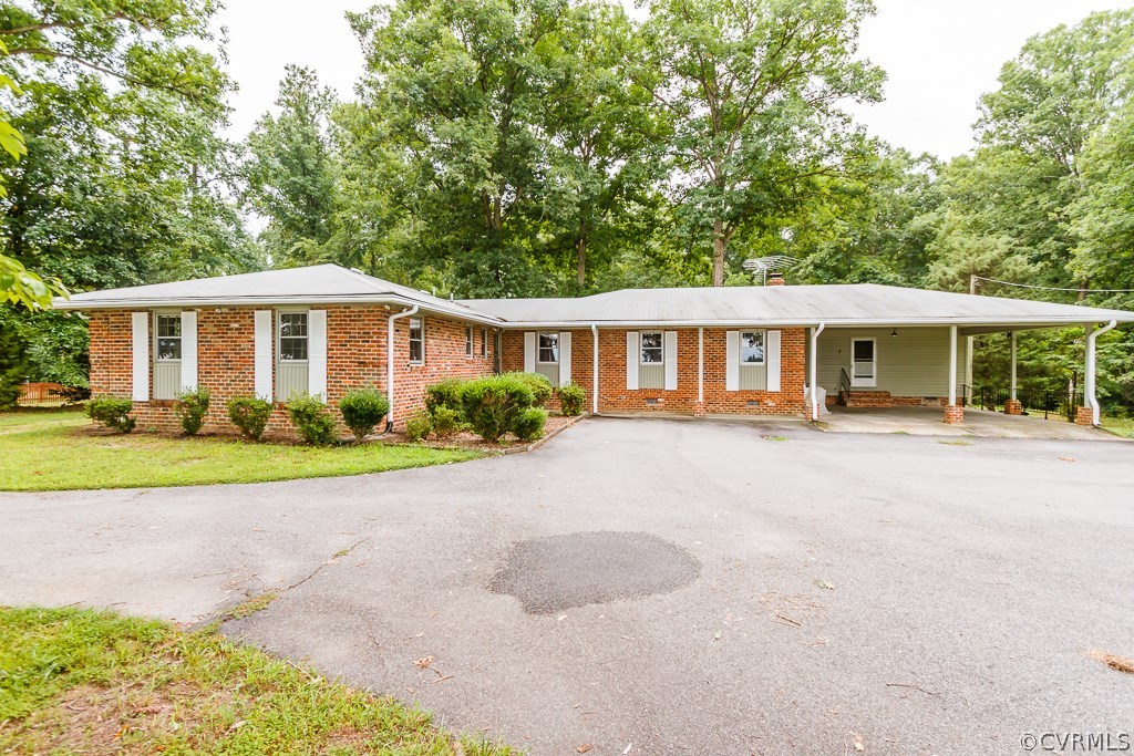 7433 River Road Hanover, VA 23069 - Photo 1 of 24 a view of a house with a yard and potted plants