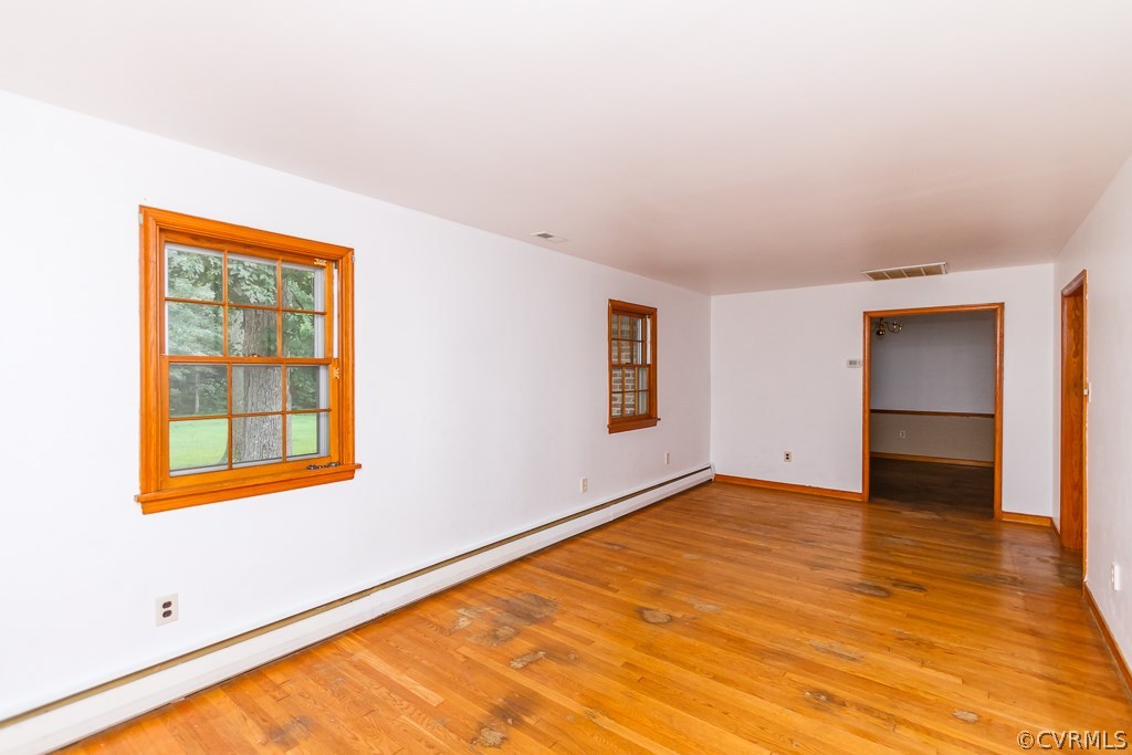 7433 River Road Hanover, VA 23069 - Photo 5 of 24 a view of an empty room with wooden floor and a window