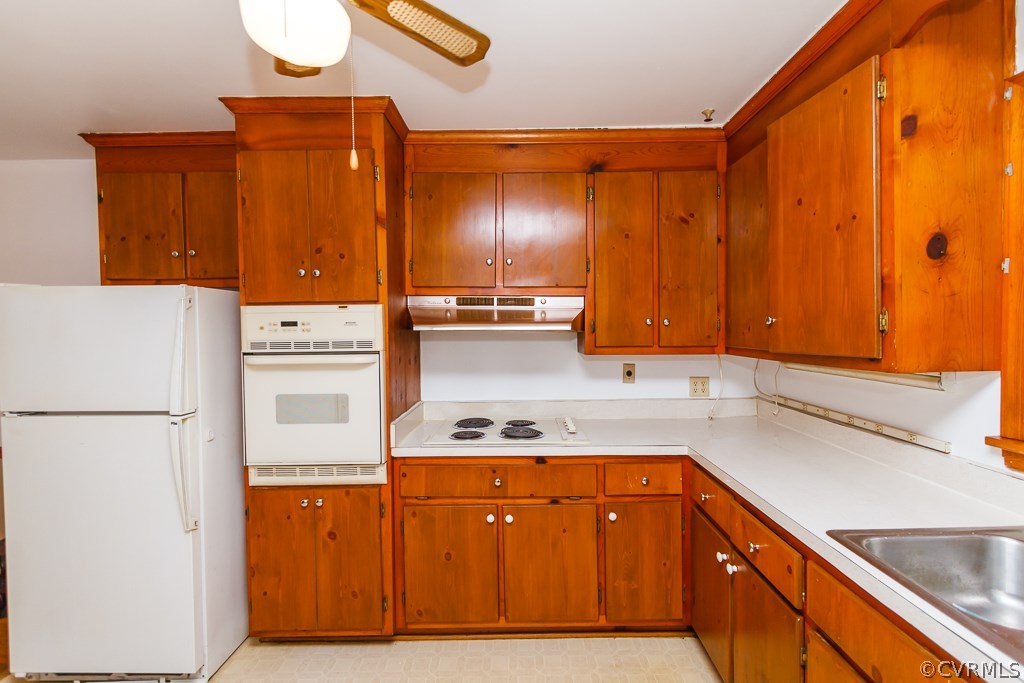 7433 River Road Hanover, VA 23069 - Photo 7 of 24 a kitchen with stainless steel appliances granite countertop a sink and a refrigerator