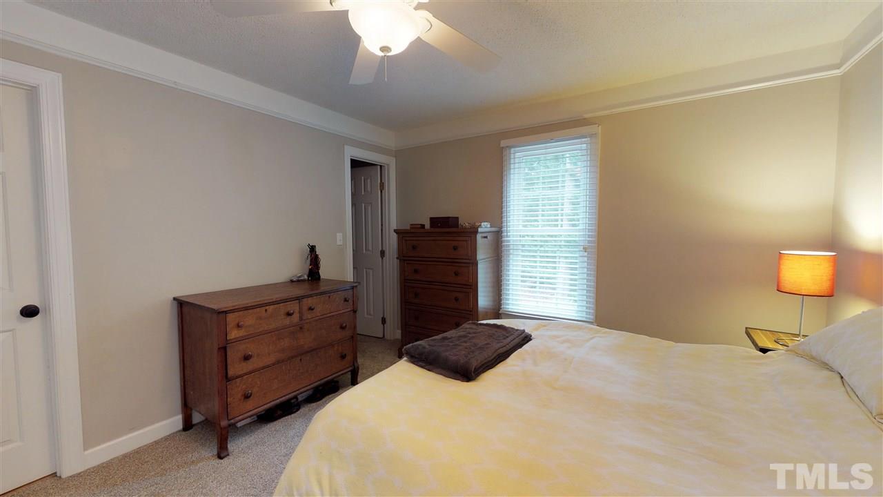 3113 East Folkestone Place Raleigh, NC 27604 - Photo 14 of 23 a bedroom with a bed and a television