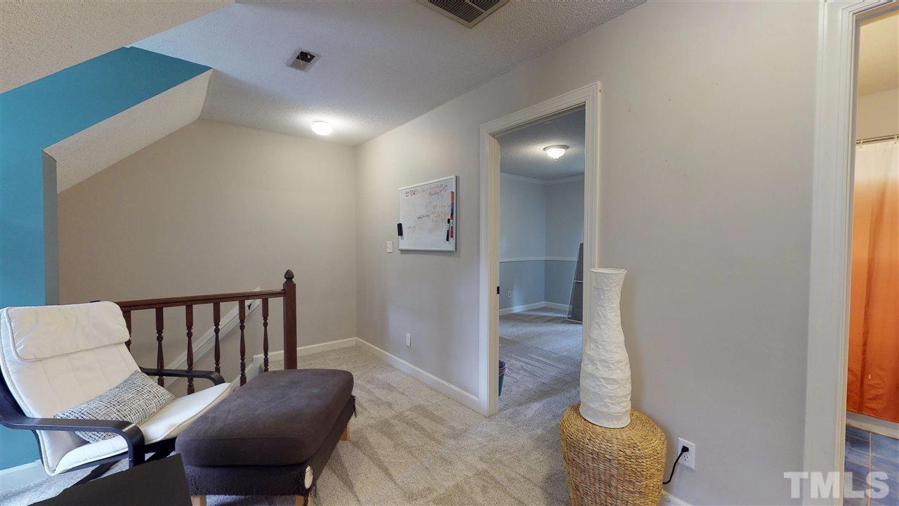 3113 East Folkestone Place Raleigh, NC 27604 - Photo 18 of 23 a view of a hallway with furniture and a livingroom view