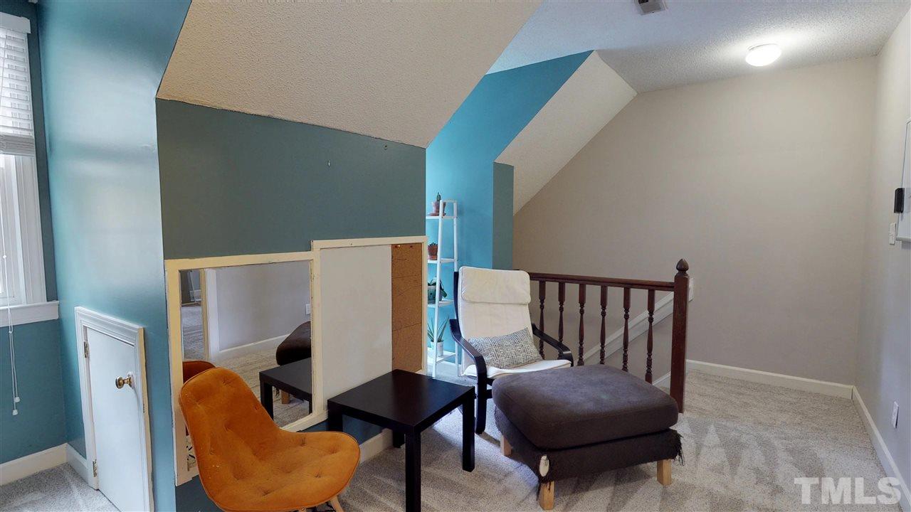 3113 East Folkestone Place Raleigh, NC 27604 - Photo 22 of 23 a living room with furniture and a chair