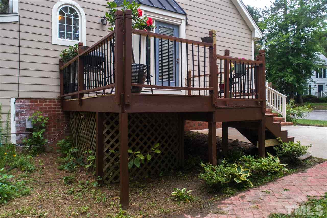 3113 East Folkestone Place Raleigh, NC 27604 - Photo 5 of 23 a view of a house with brick walls and flower plants