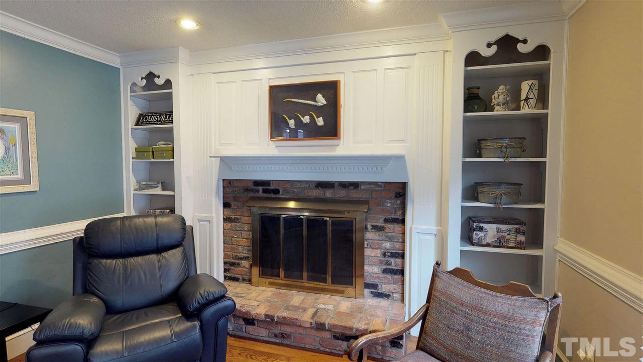 3113 East Folkestone Place Raleigh, NC 27604 - Photo 8 of 23 a living room with furniture and a fireplace