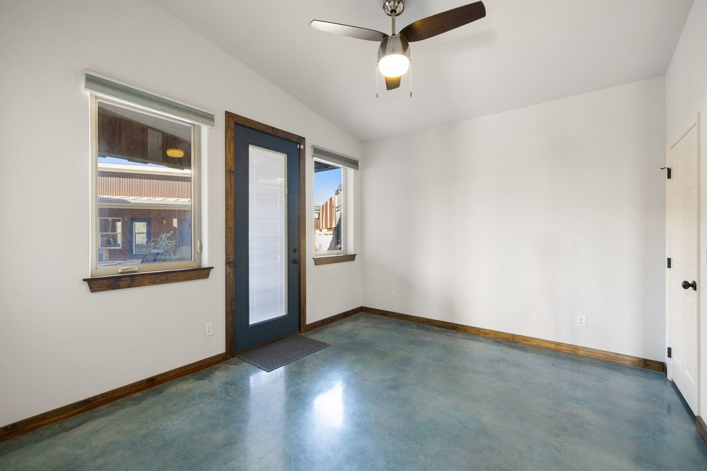 1292 Upper Turtle Creek Road Kerrville, TX 78028 - Photo 17 of 40 Spare room with concrete floors, lofted ceiling, and a ceiling fan