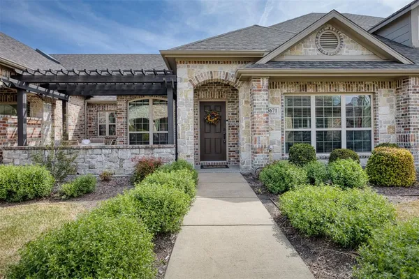 a kitchen with stainless steel appliances granite countertop a stove top oven a dining table and chairs with wooden floor