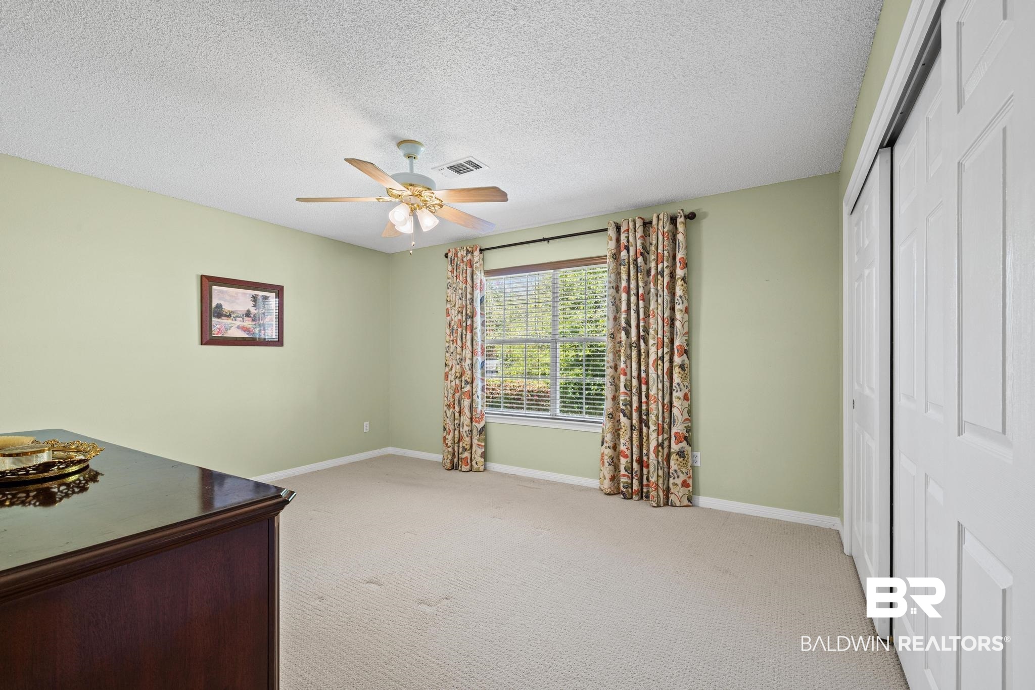 2881 Eslava Circle Lillian, AL 36549 - Photo 12 of 58 Bedroom with light carpet, a closet, a textured ceiling, and ceiling fan