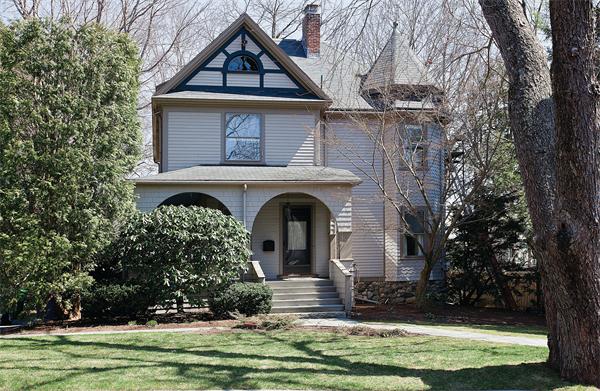 a front view of a house with a garden