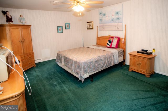 a bed sitting in a room next to a window