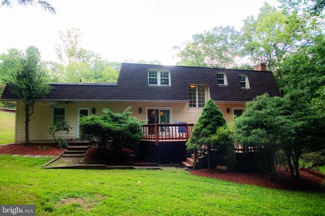 a view of a house with a yard and a garden