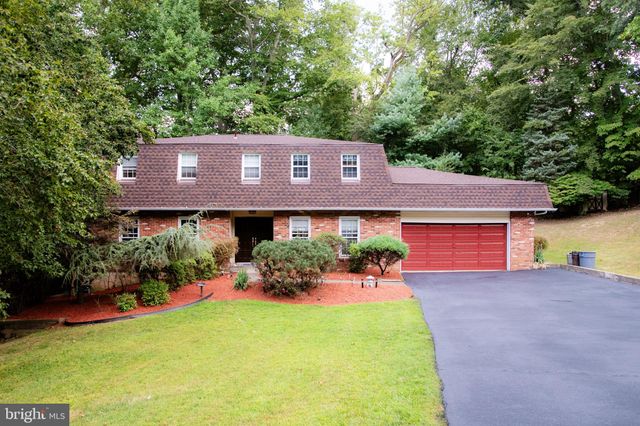 a view of a house with a yard and potted plants