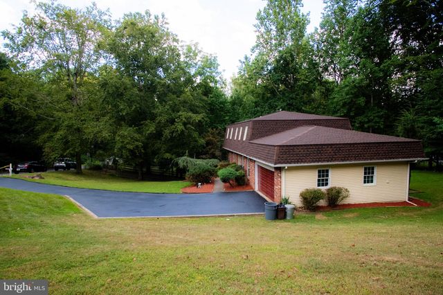 a aerial view of a house with swimming pool and yard