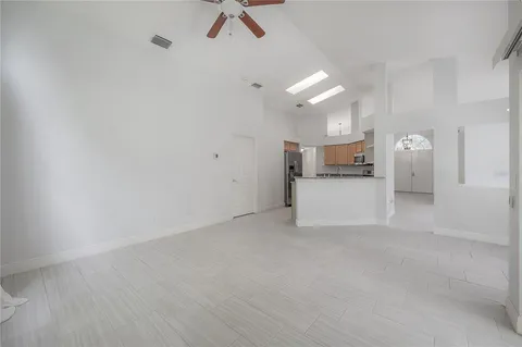a spacious bathroom with a double vanity sink a large mirror and a bathtub