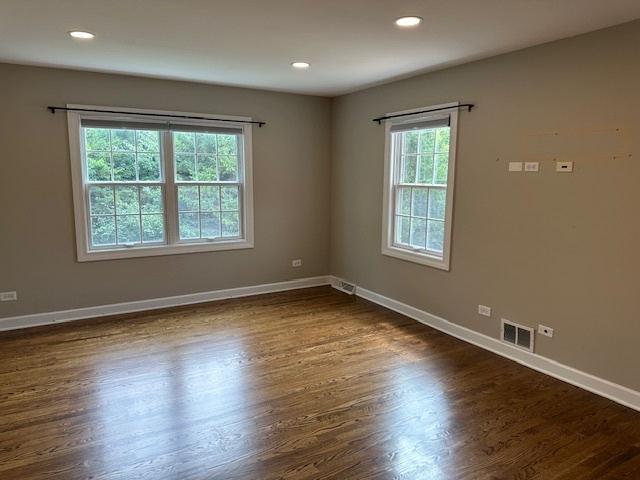 1253 West Illinois Avenue Palatine, IL 60067 - Photo 11 of 18 a view of an empty room with wooden floor and a window