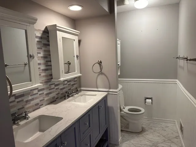 a bathroom with a sink toilet and shower