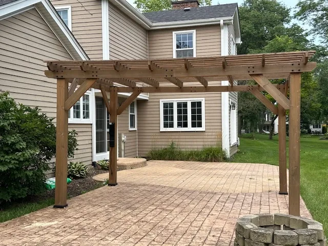 a front view of a house with a yard and potted plants