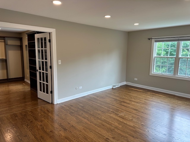 1253 West Illinois Avenue Palatine, IL 60067 - Photo 10 of 18 a view of empty room with wooden floor and fan