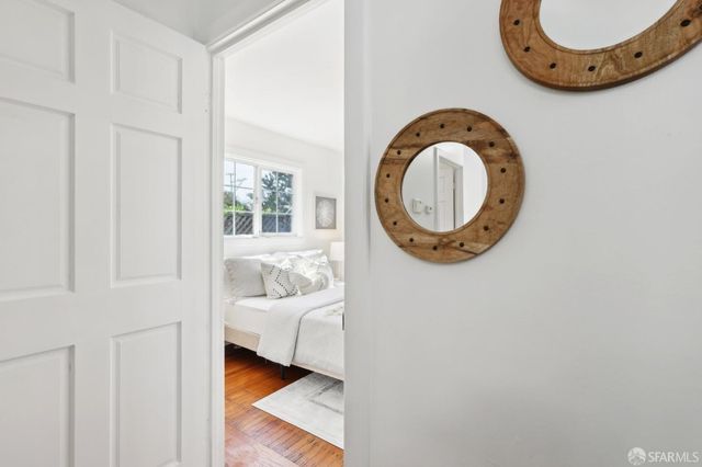 a view of a bedroom with a bed and a window