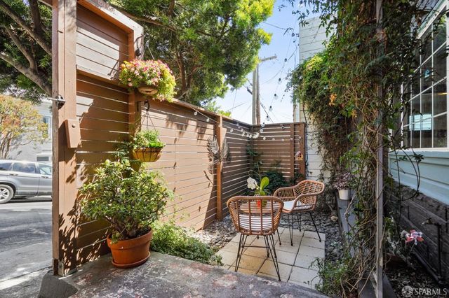 a view of a patio with table and chairs and potted plants