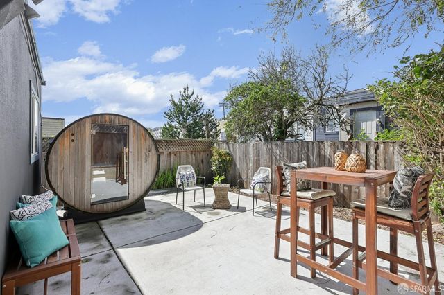 an outdoor space with furniture and garden