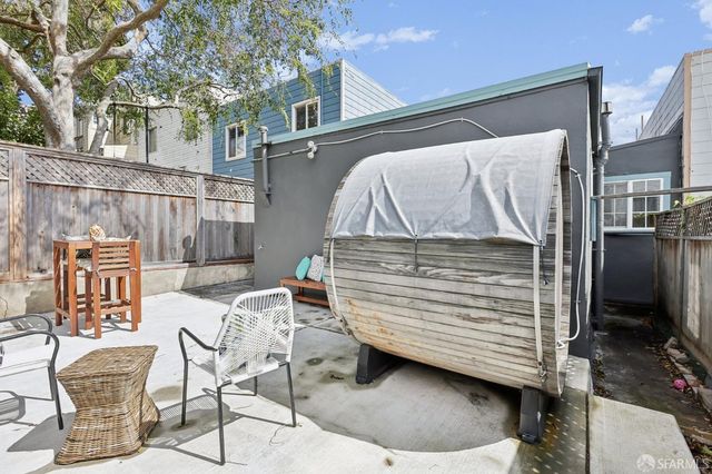 a view of a patio with a table and chairs