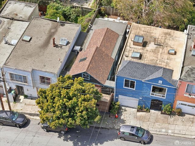 a view of a street with potted plants