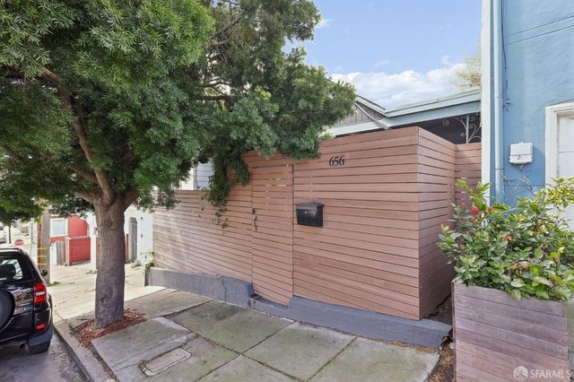 a view of a car park in front of a house