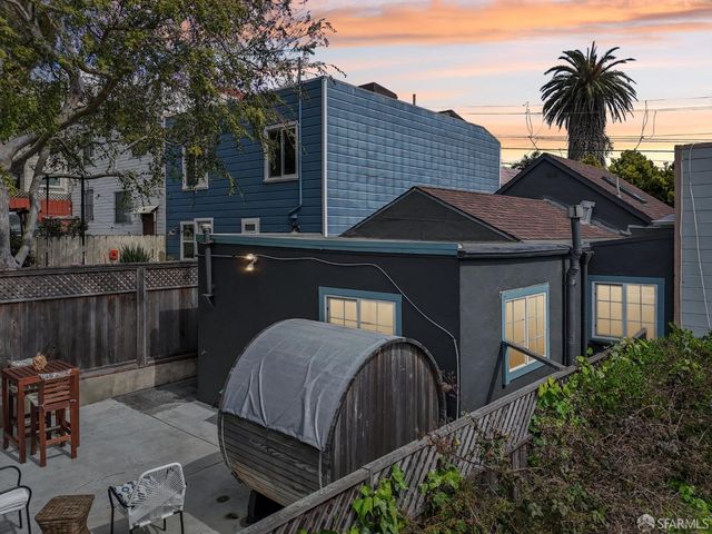 a front view of house with yard and trees around