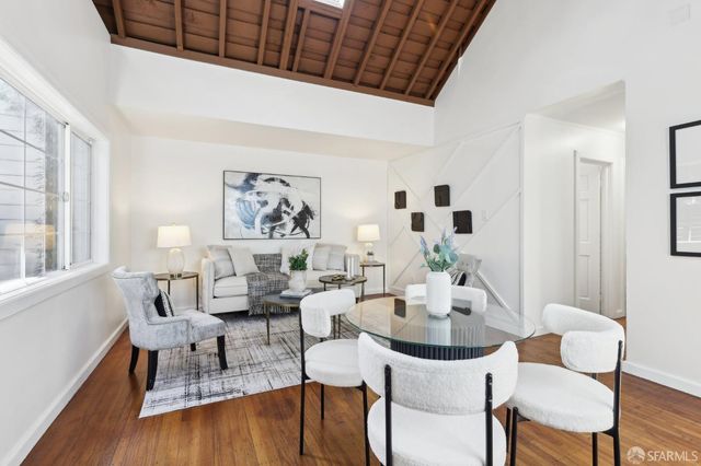 a view of a dining room with furniture window and wooden floor