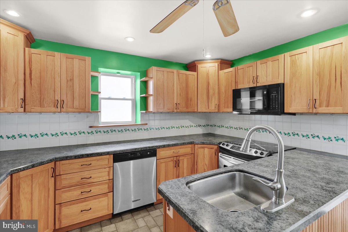 27 Woodland Road Reading, PA 19610 - Photo 9 of 34 a kitchen with granite countertop a sink stainless steel appliances and cabinets