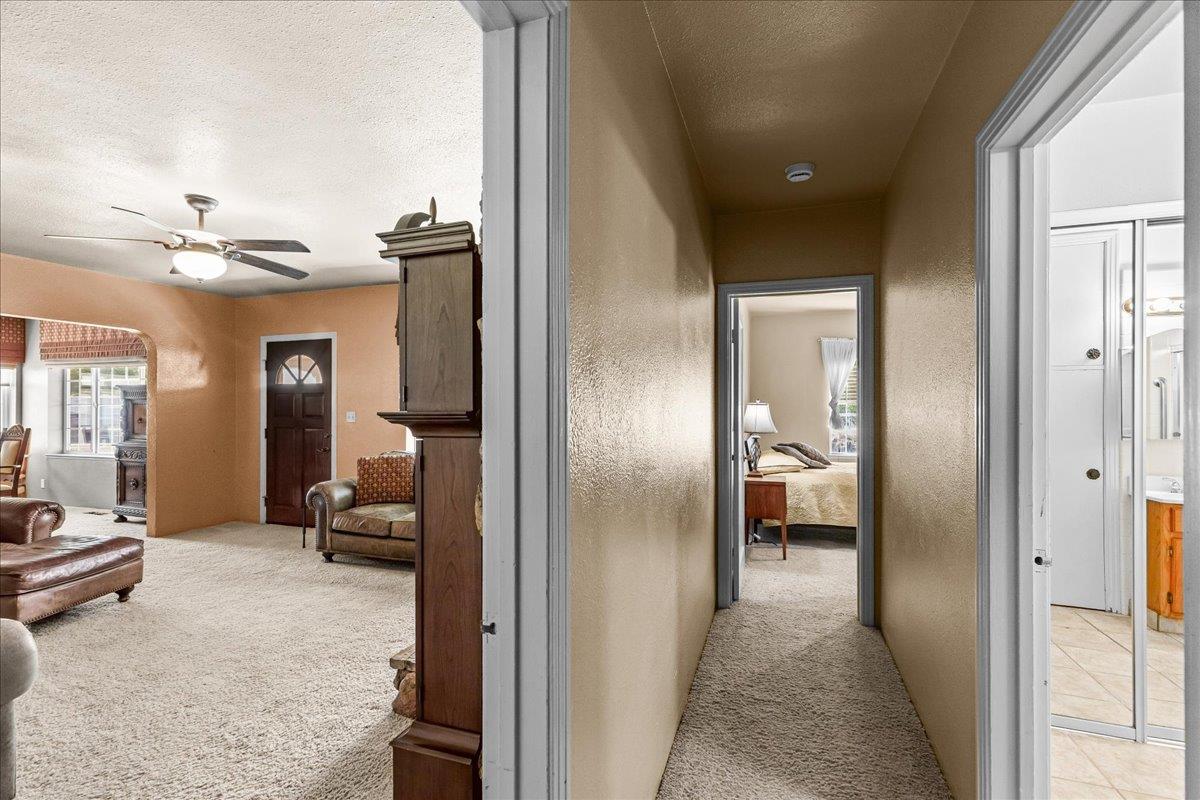 4701 Lone Tree Road Valley Home, CA 95361 - Photo 36 of 59 a view of a hallway with living room and furniture