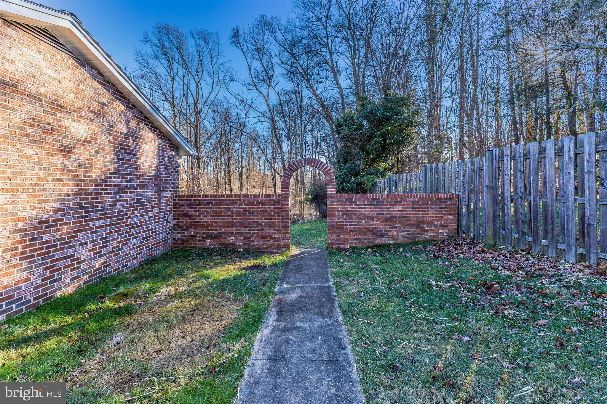 2233 Kings House Road Silver Spring, MD 20905 - Photo 6 of 36 Brick archway leading to the back yard