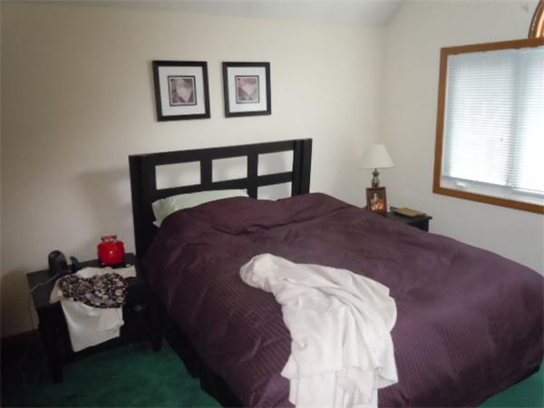 8 David Drive, Unit 8 Natick, MA 01760 - Photo 8 of 9 a bed sitting in a bedroom and chair next to a window