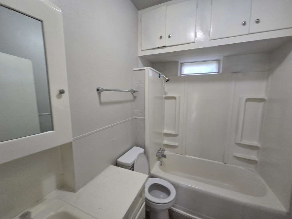1824 Magnolia Street Liberty, TX 77575 - Photo 15 of 17 a bathroom with a toilet and bathtub