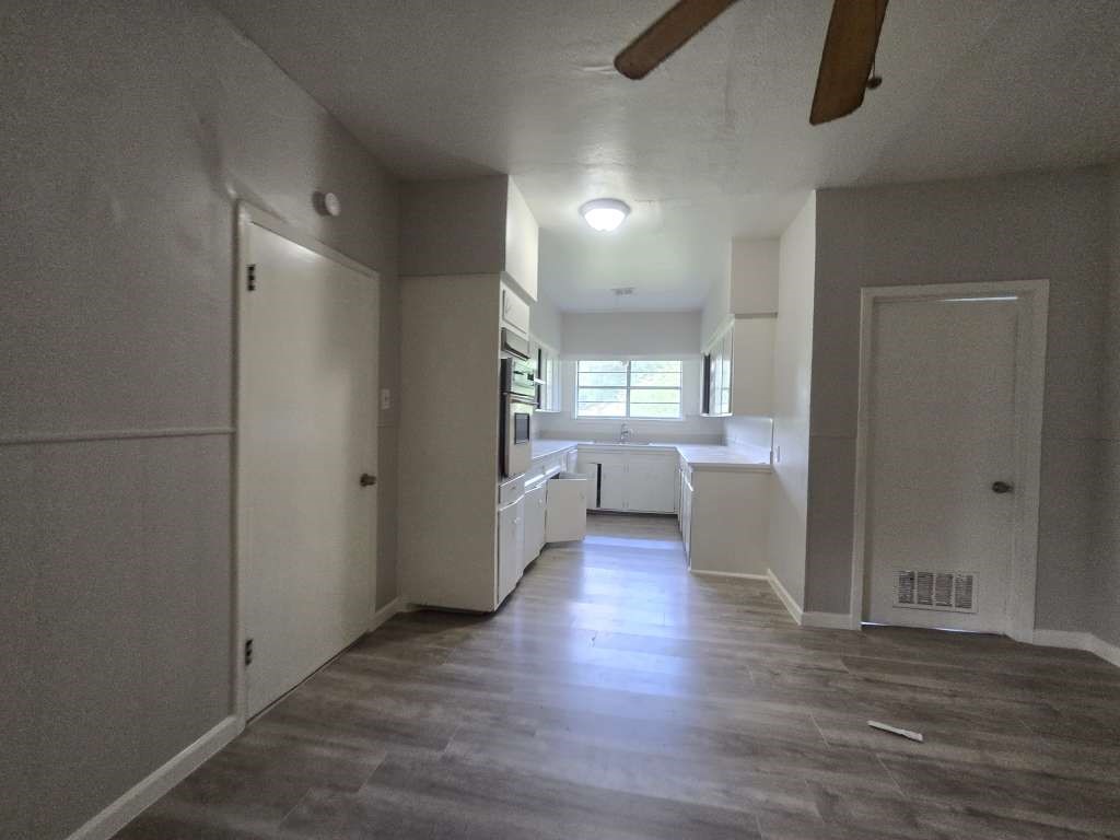 1824 Magnolia Street Liberty, TX 77575 - Photo 17 of 17 an empty room with wooden floor and windows