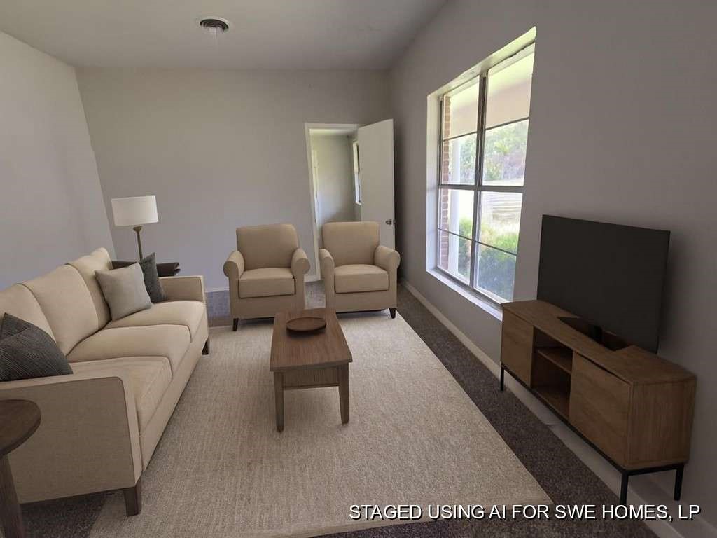 1824 Magnolia Street Liberty, TX 77575 - Photo 9 of 17 a living room with furniture and a flat screen tv