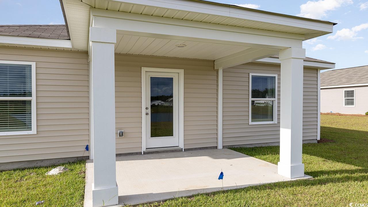 1019 St Martin Street Georgetown, SC 29440 - Photo 4 of 33 Property entrance with a lawn and a patio area