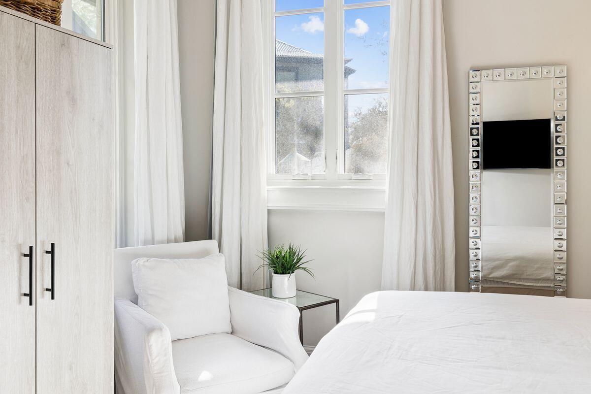 216 Round Road Rosemary Beach, FL 32461 - Photo 24 of 58 a bedroom with a bed a couch and a window