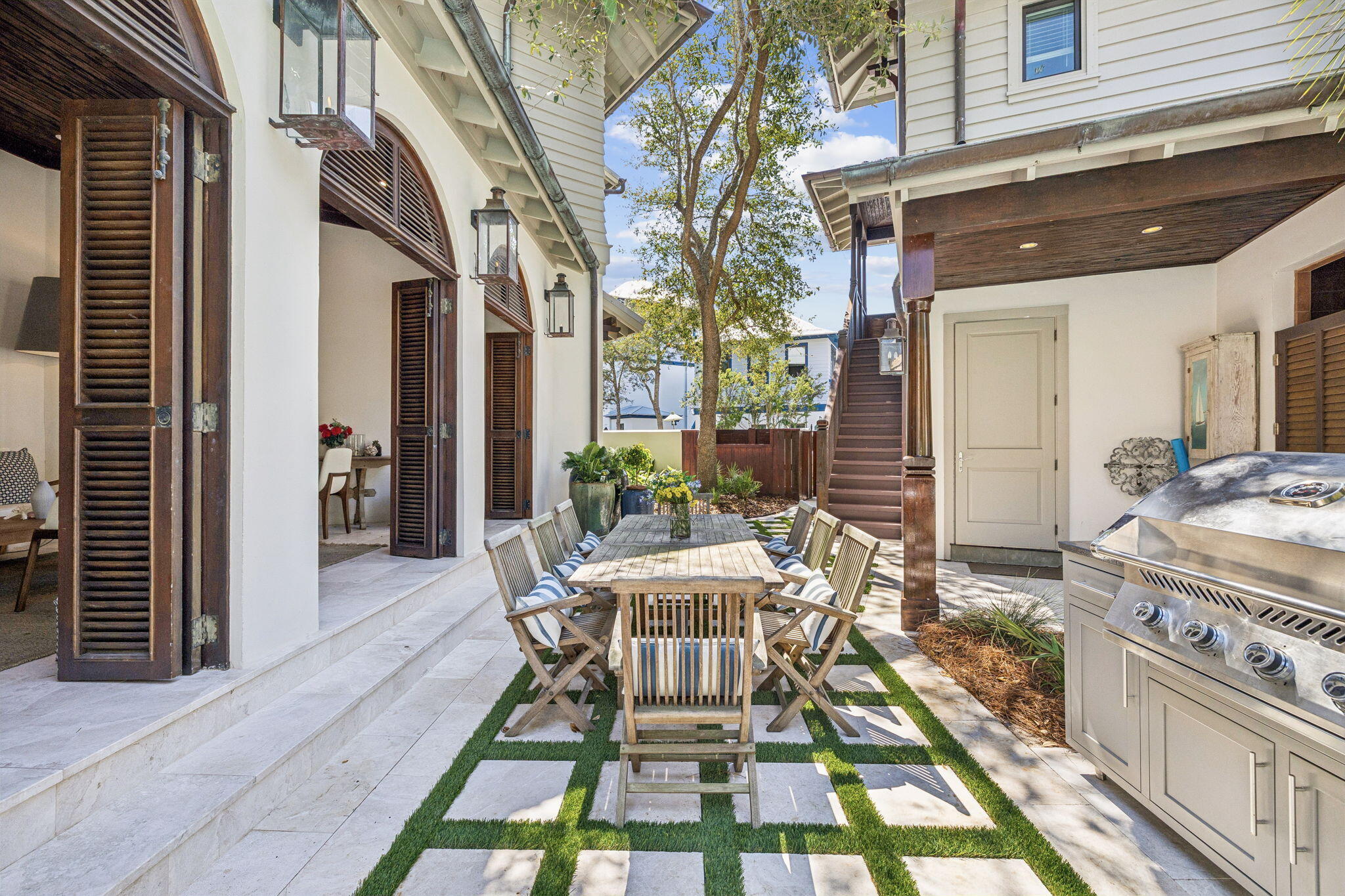 216 Round Road Rosemary Beach, FL 32461 - Photo 6 of 58 a view of a patio with table and chairs and potted plants