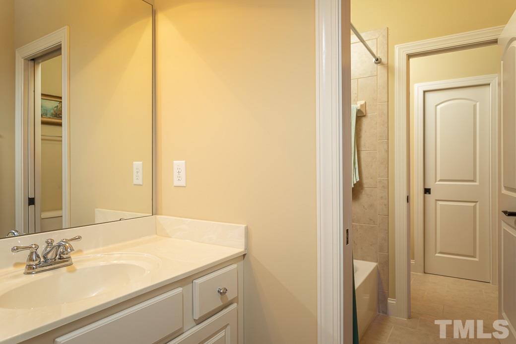 1319 Ileagnes Road Raleigh, NC 27603 - Photo 22 of 30 a bathroom with a sink and a mirror