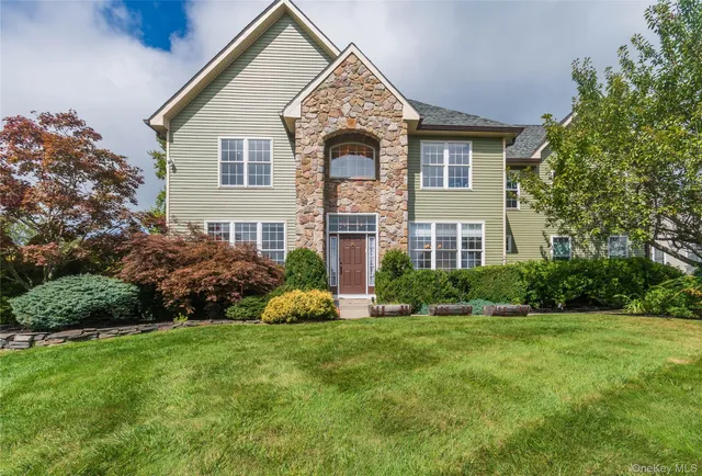 a front view of a house with a garden and plants